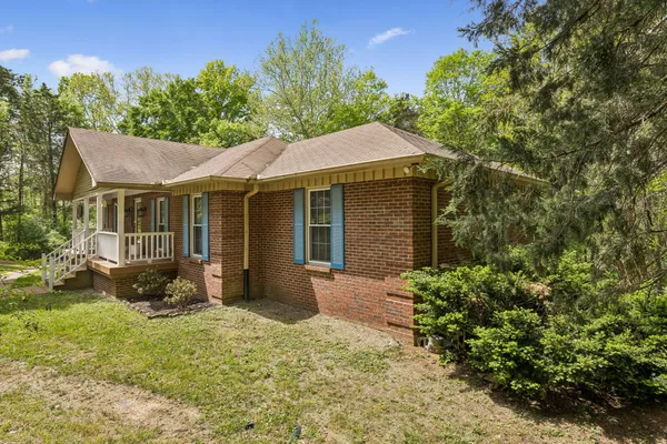 a front view of a house with a garden and porch