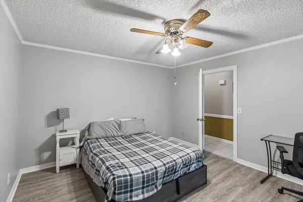 a bedroom with a bed and a chandelier