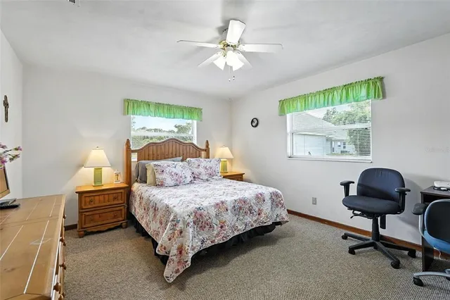 a bedroom with a bed a window and a chandelier