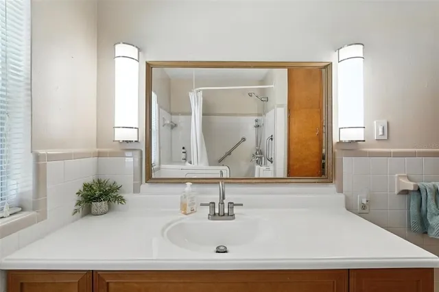 a bedroom with 2 bed and a chandelier