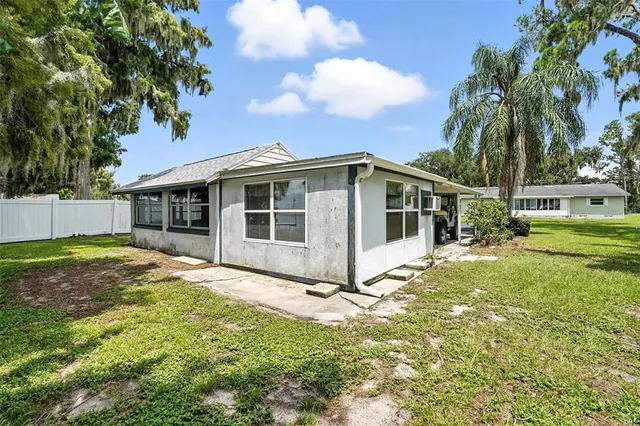 a dining room with furniture a kitchen view and a refrigerator