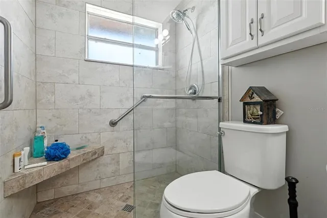 a bedroom with furniture and a large window