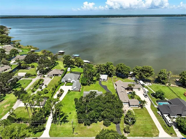 a small white house with a large pool