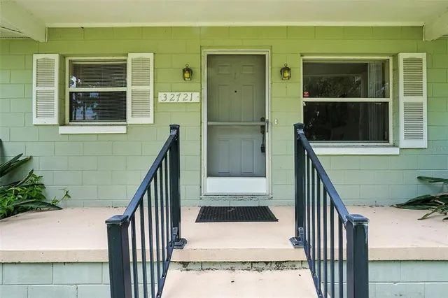 a view of balcony with wooden floor and a potted plant