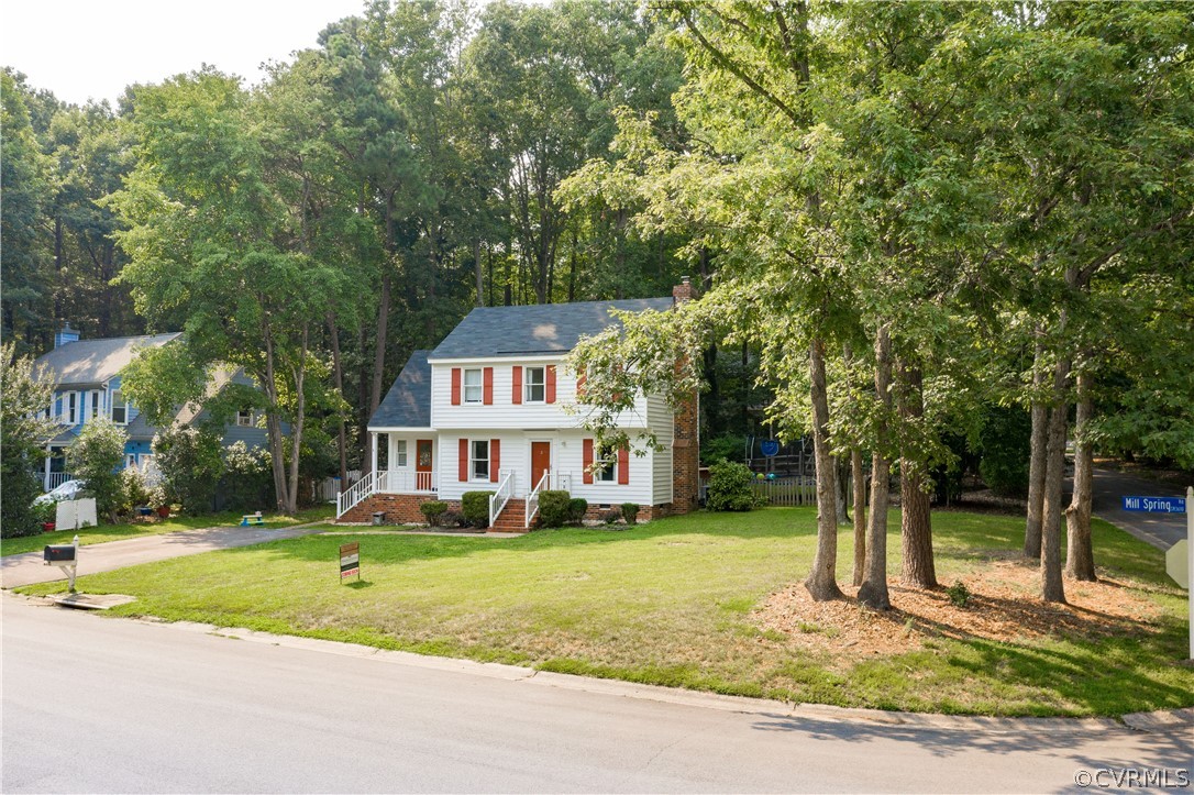 5900 Mill Spring Road Midlothian, VA 23112 - Photo 5 of 41 a view of a white house with a big yard and large trees