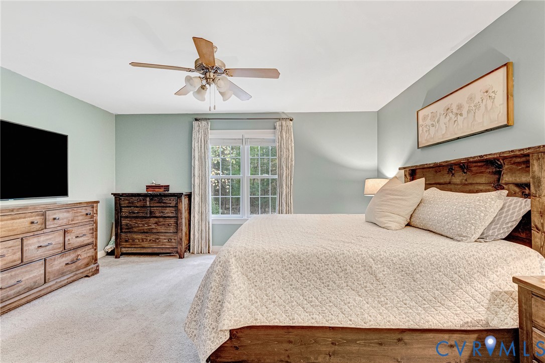 109 Pleasant Grove Court Aylett, VA 23009 - Photo 20 of 39 a bedroom with a bed and a flat screen tv