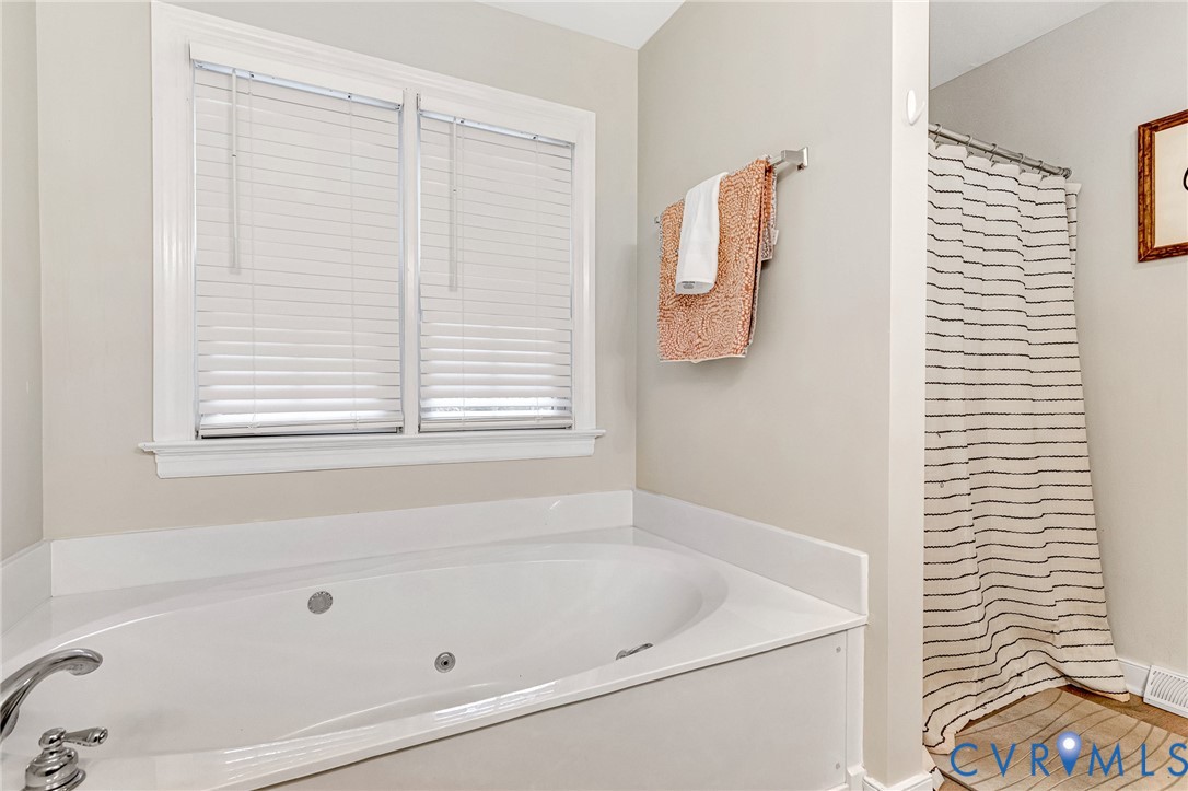 109 Pleasant Grove Court Aylett, VA 23009 - Photo 24 of 39 a bath tub sitting next to a window