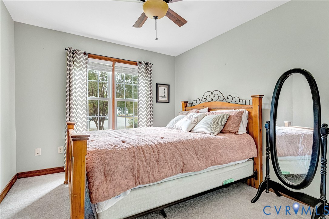109 Pleasant Grove Court Aylett, VA 23009 - Photo 30 of 39 a bedroom with a bed and a mirror