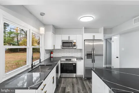 a kitchen with a refrigerator a sink and a stove