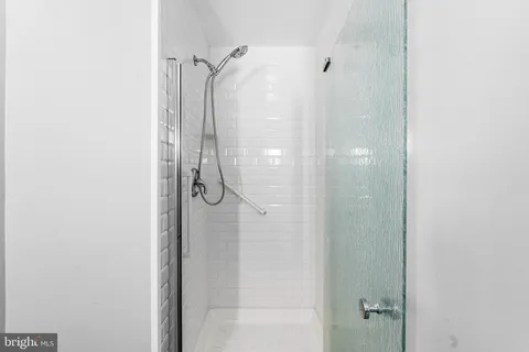 a bathroom with a glass shower door