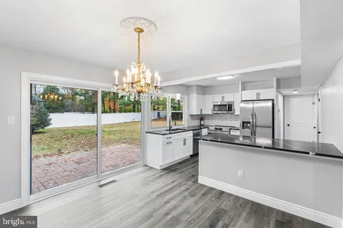 a kitchen with stainless steel appliances granite countertop a stove and refrigerator