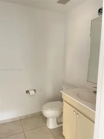 a white toilet sitting next to a bath tub