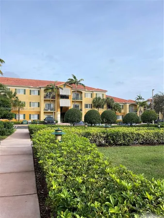 a view of a building with a yard