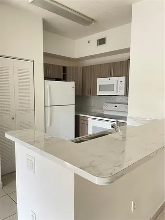 a close view of a refrigerator a sink and dishwasher