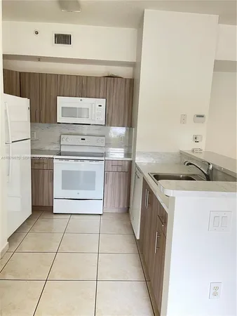 a kitchen with a stove top oven and cabinets