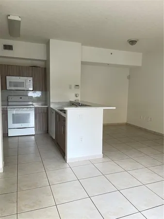 a kitchen with a stove top oven and cabinets