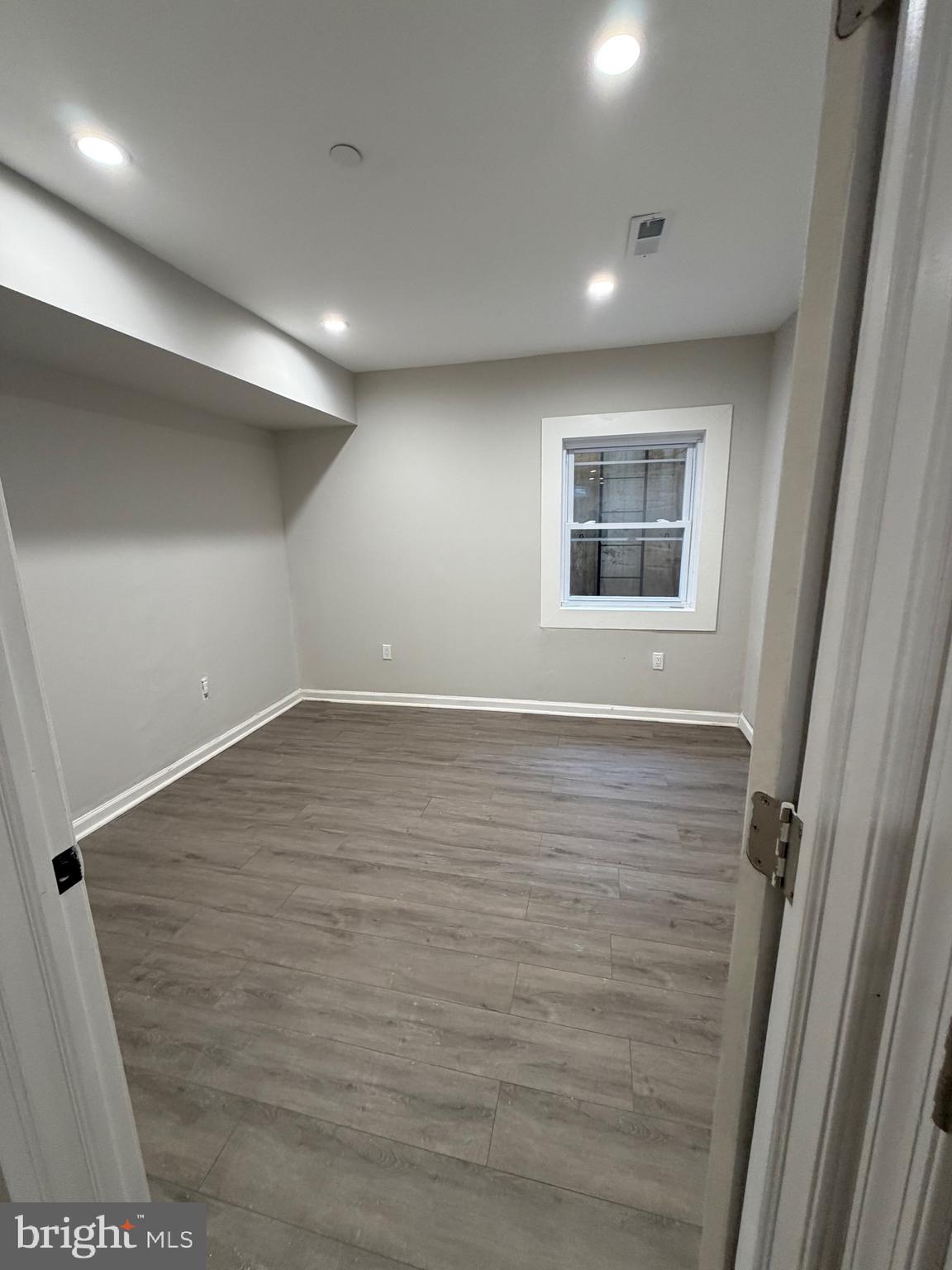 2218 Master Street Philadelphia, PA 19121 - Photo 27 of 66 en empty room with wooden floor and window