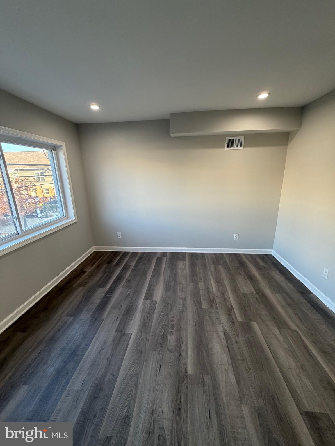 2218 Master Street Philadelphia, PA 19121 - Photo 42 of 66 an empty room with wooden floor and windows