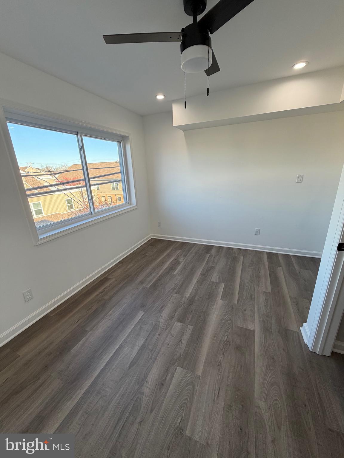 2218 Master Street Philadelphia, PA 19121 - Photo 57 of 66 an empty room with wooden floor fan and windows