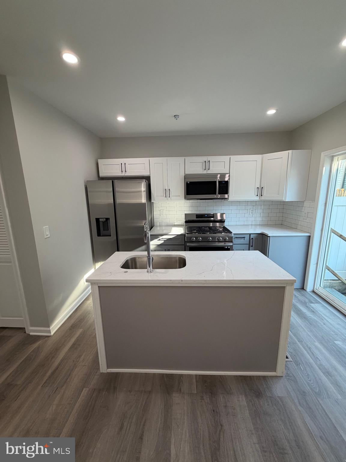 2218 Master Street Philadelphia, PA 19121 - Photo 6 of 66 a view of kitchen with stainless steel appliances a refrigerator a sink a stove top oven a wooden floor