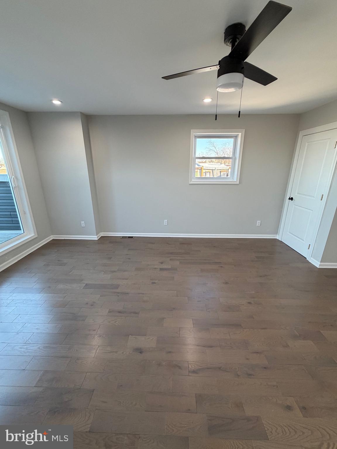 2218 Master Street Philadelphia, PA 19121 - Photo 61 of 66 an empty room with wooden floor ceiling fan and windows