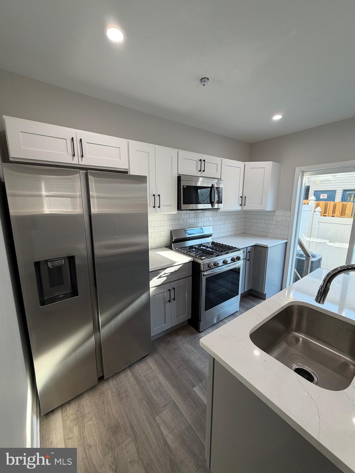 2218 Master Street Philadelphia, PA 19121 - Photo 7 of 66 a kitchen with stainless steel appliances a refrigerator a sink a stove a microwave a sink a refrigerator and cabinets