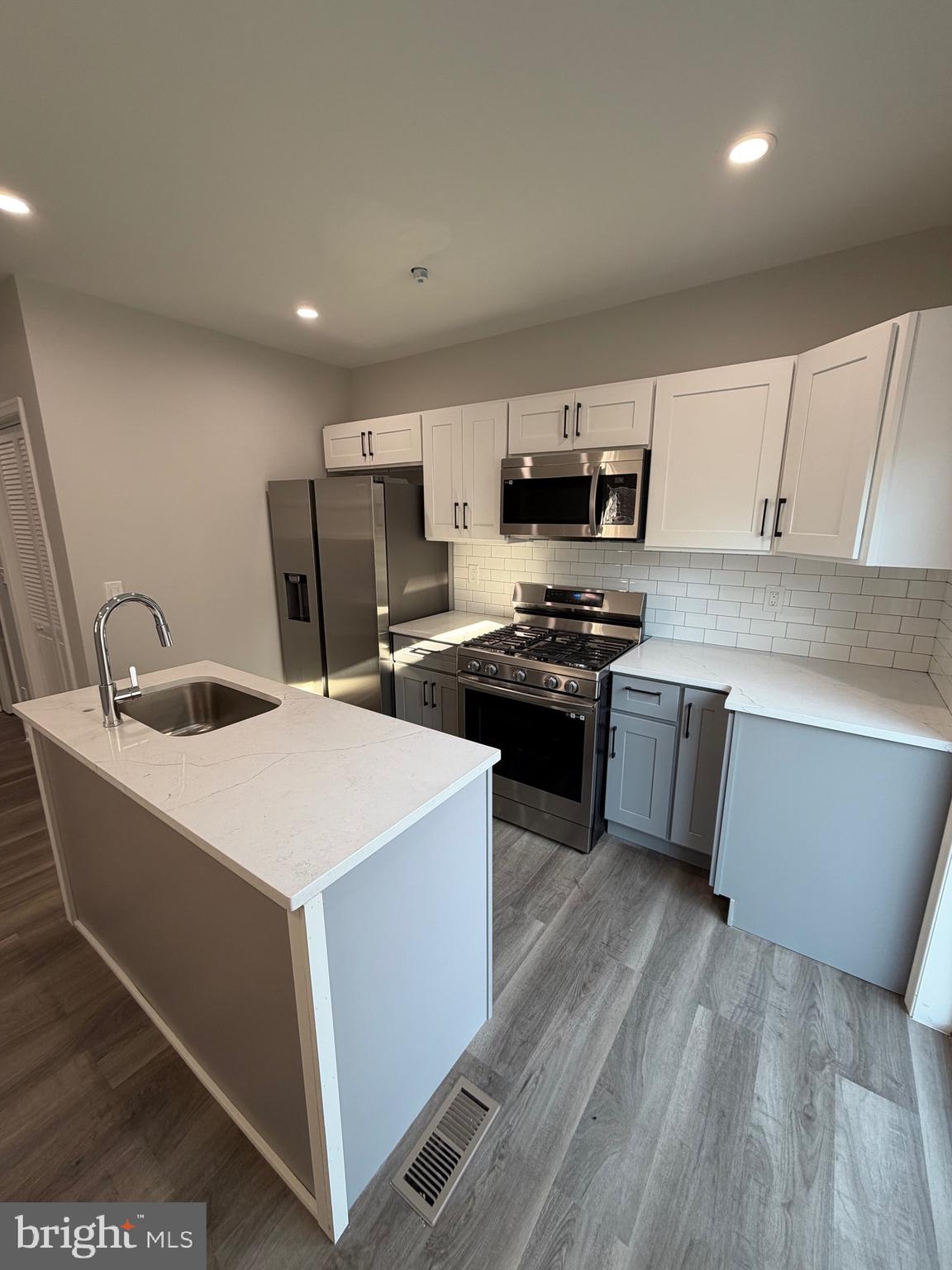2218 Master Street Philadelphia, PA 19121 - Photo 8 of 66 a kitchen with a sink a stove top oven a counter space and cabinets