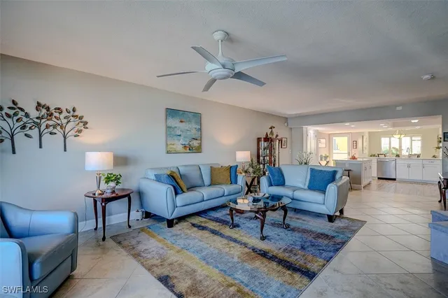 a living room with furniture a rug and a chandelier