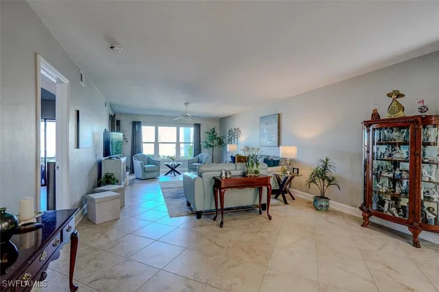a living room with furniture a window and a piano
