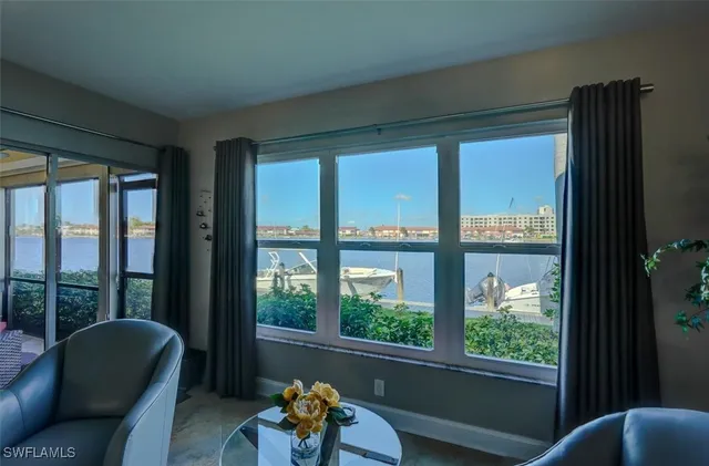 a living room filled with furniture and a large window