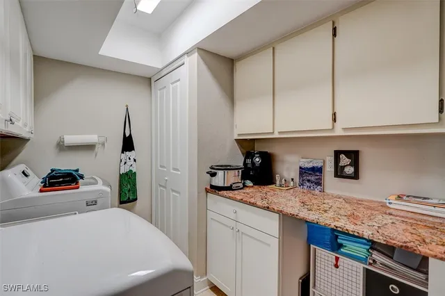 a kitchen with granite countertop cabinets and utility