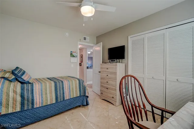 a bedroom with furniture and a flat screen tv