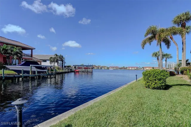 a lake with lots of green space and houses