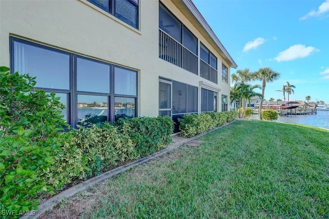 a view of a house with a yard and sitting area