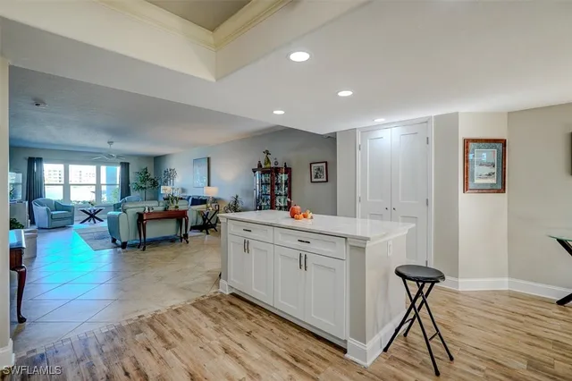 a view of living room and kitchen with furniture and wooden floor