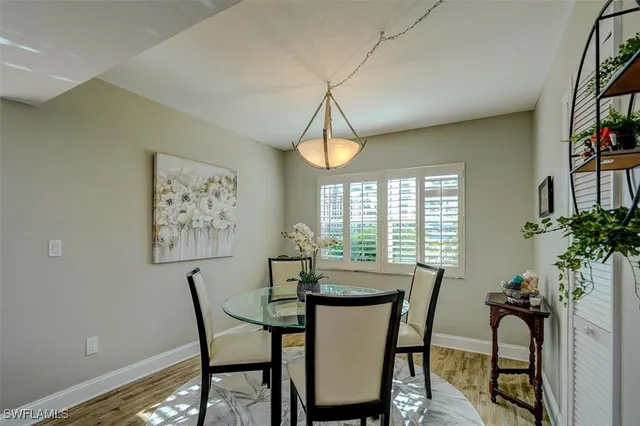 a dining room with furniture and window