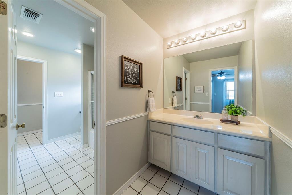 1992 Bledsoe Road Gunter, TX 75058 - Photo 21 of 40 a spacious bathroom with a granite countertop sink mirror and shower