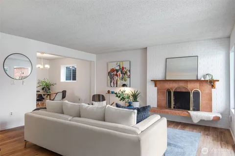 a dining room with furniture potted plants and wooden floor