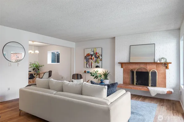 a dining room with furniture potted plants and wooden floor
