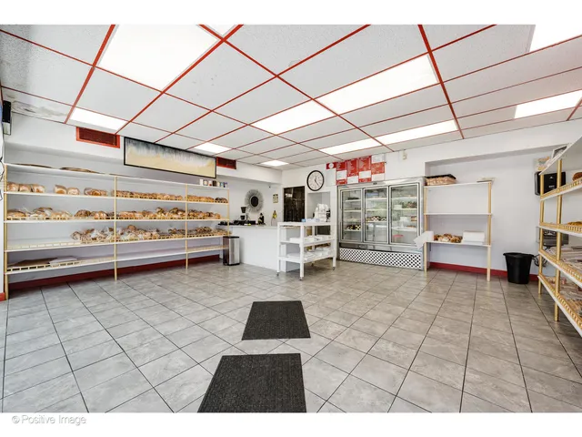 a kitchen that has a lot of white cabinets
