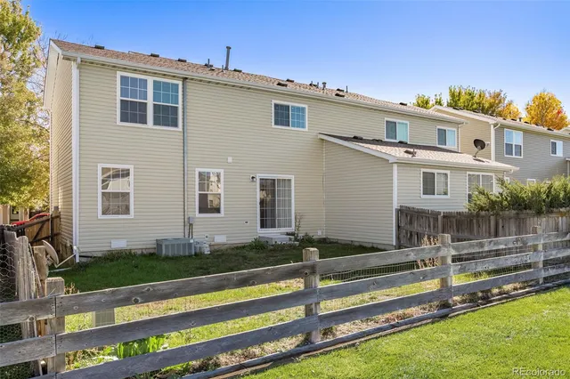 a front view of a house with a yard table and chairs