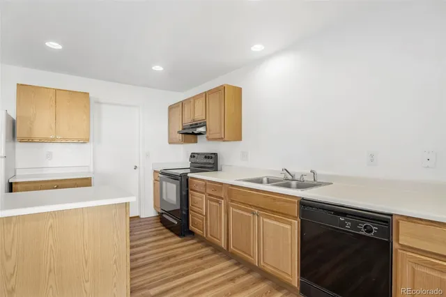 a kitchen with a sink stove and refrigerator