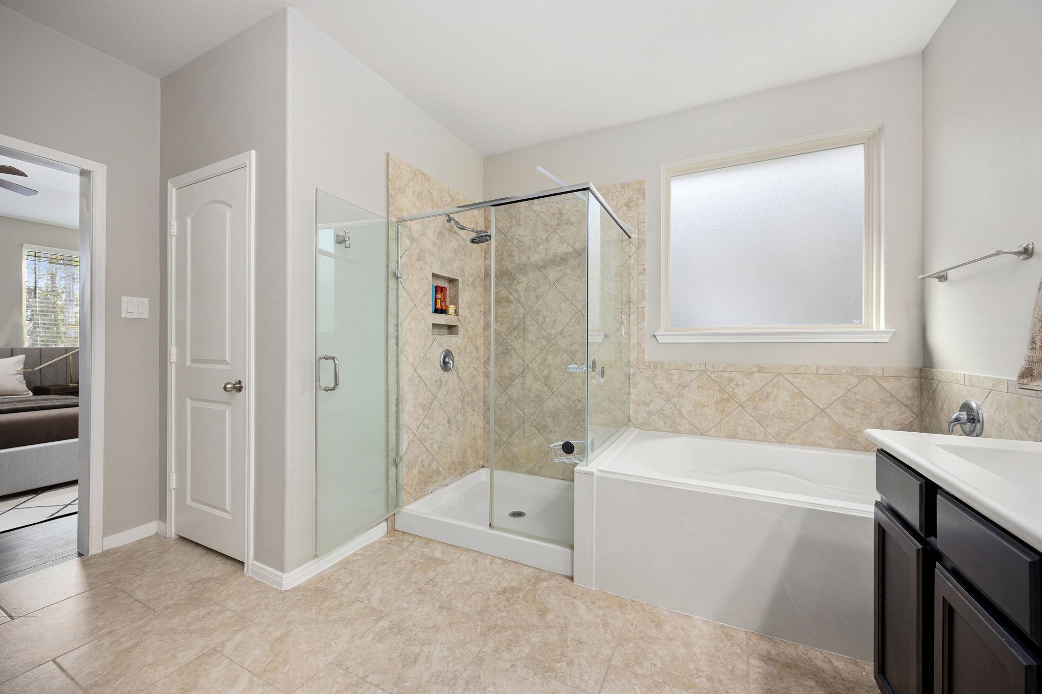 14023 Beaverhead Range Court Conroe, TX 77384 - Photo 15 of 29 This primary bathroom provides the best of both worlds, catering to both quick morning routines and relaxing evening soaks.