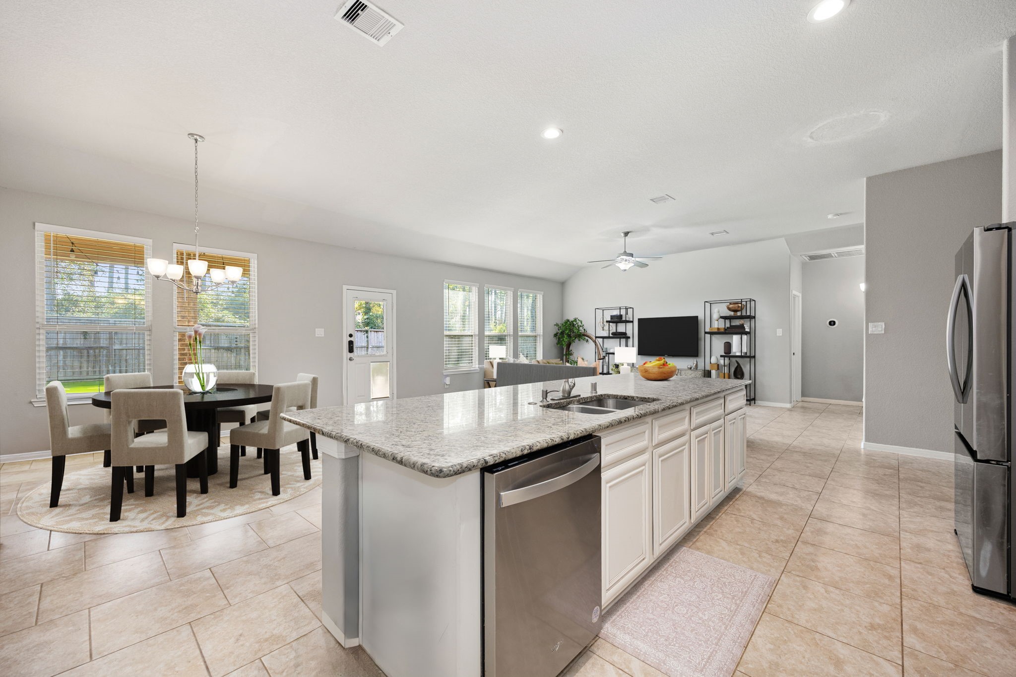 14023 Beaverhead Range Court Conroe, TX 77384 - Photo 9 of 29 Experience a truly commanding view from the heart of this open-concept home! The windows create a seamless visual connection to the outdoors, offering picturesque views of the private backyard. *Virtually Staged