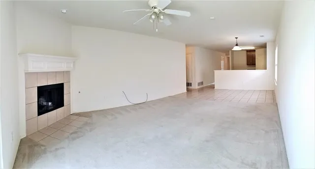 a view of an empty room with a fireplace