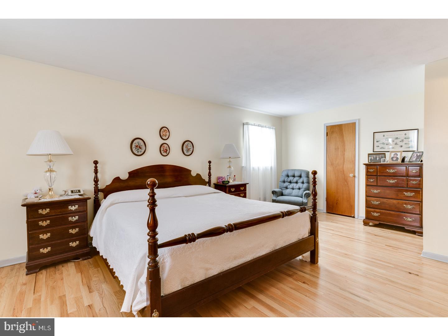 4 Manor Road Hamilton, NJ 08690 - Photo 16 of 25 a bedroom with a bed and wooden floor