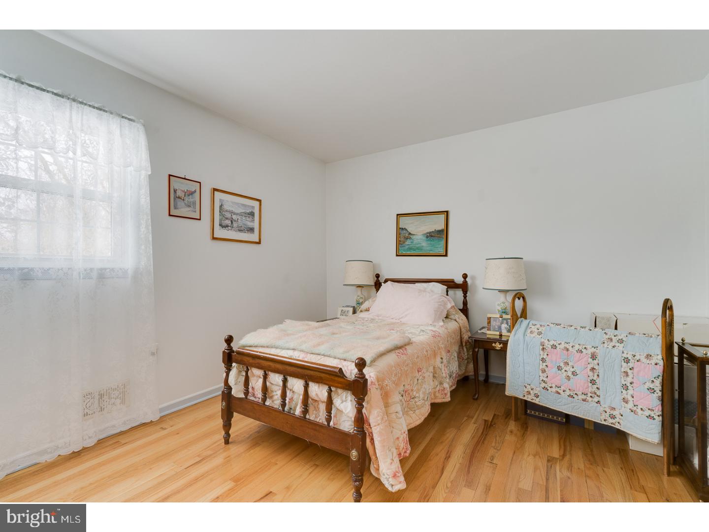 4 Manor Road Hamilton, NJ 08690 - Photo 21 of 25 a bedroom with a bed and wooden floor