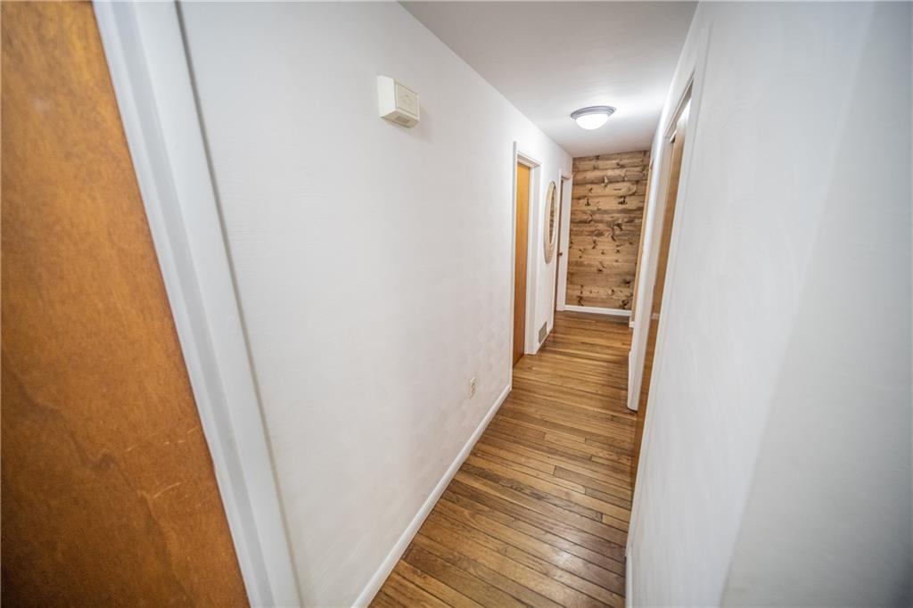 113 Oak Ridge Drive Butler, PA 16002 - Photo 14 of 25 a view of a hallway with wooden floor and staircase