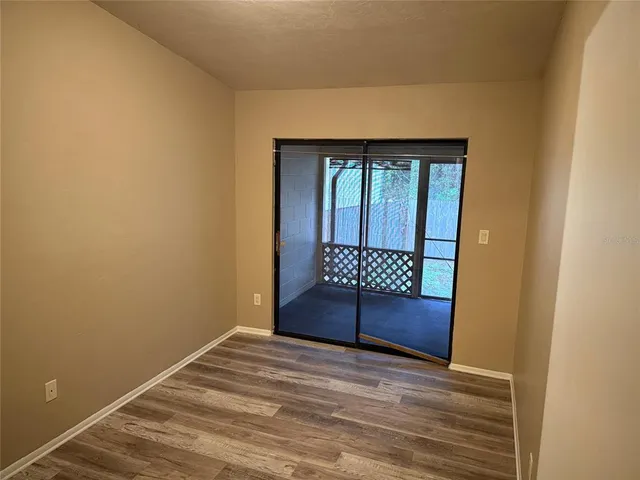 a view of a room with wooden floor and bathroom