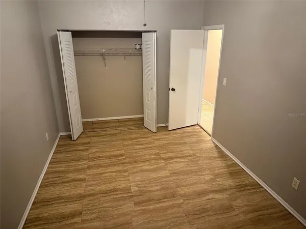 a view of hallway with wooden floor